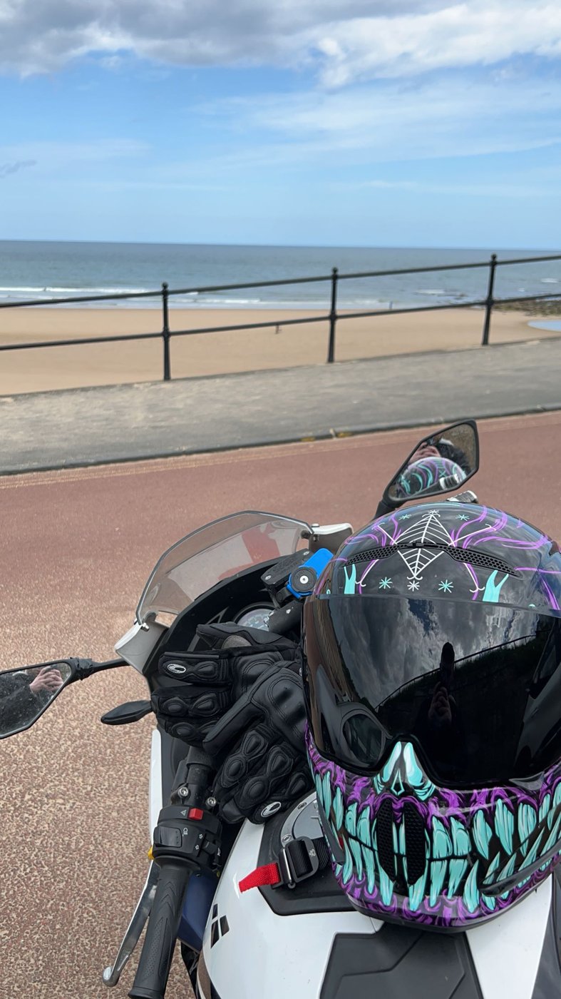 Motorbike parked on the seafront with my helmet and gloves