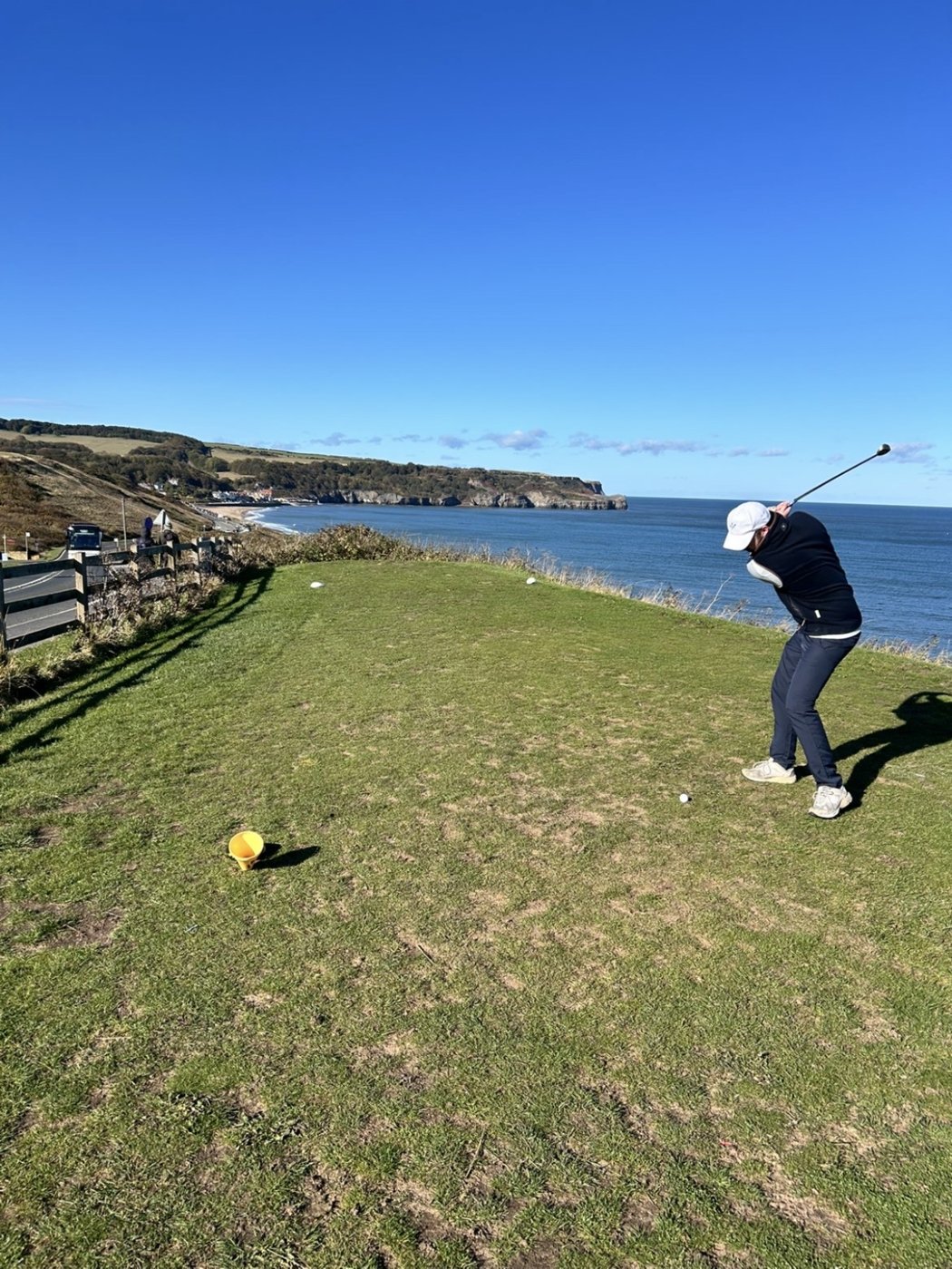Teeing off on a clifftop golf course by the sea