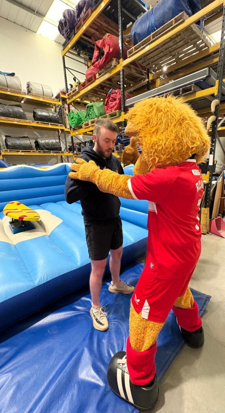 Getting a hug from a football mascot
