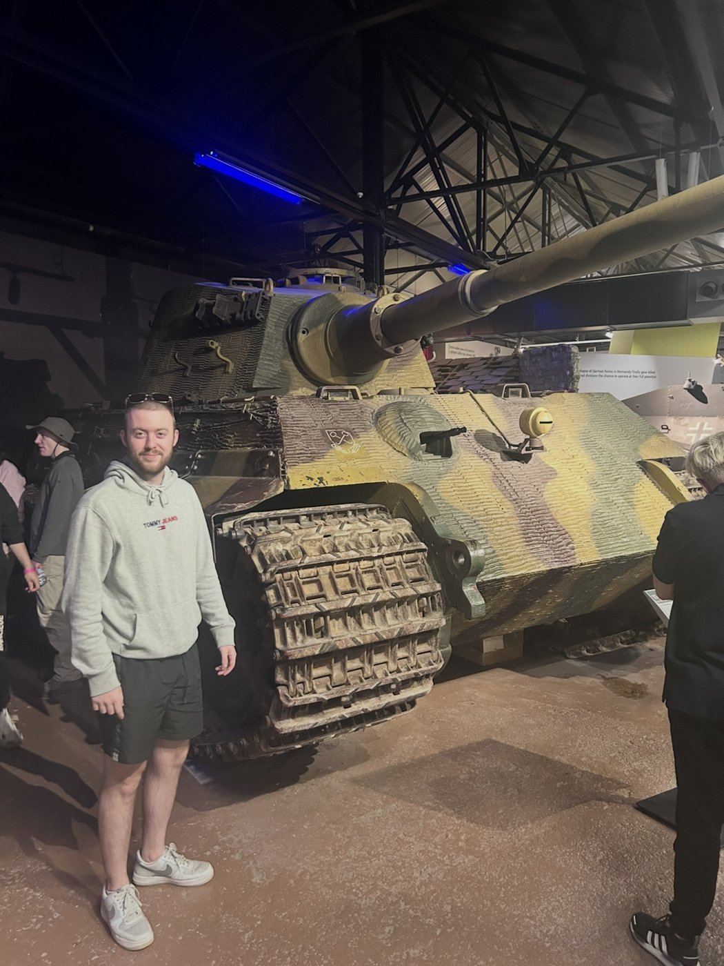 Standing next to a tank at a museum