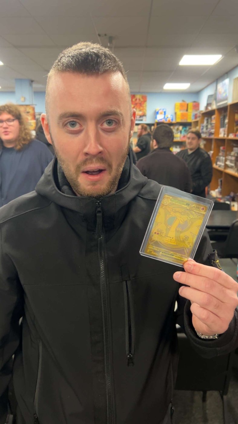 Holding up a gold Pokémon card